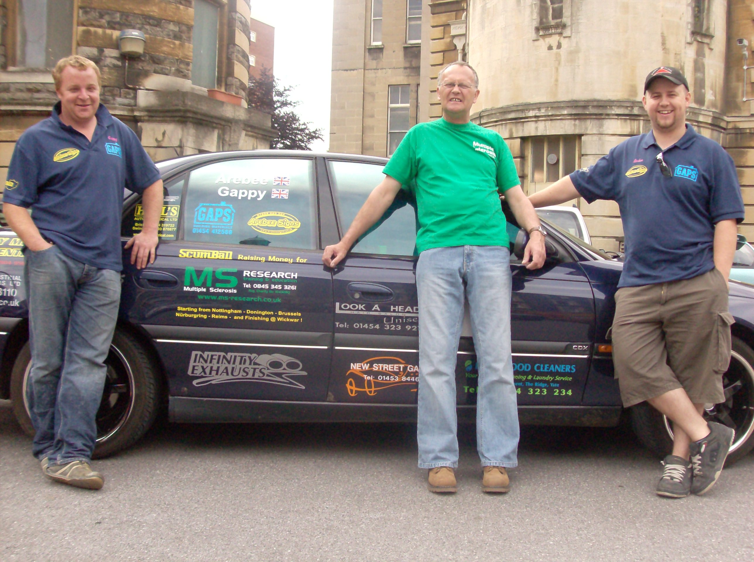 scumball drivers for MS Research with Brian Pagington pointing at the charity logo in the middle 