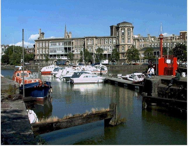 Bridtol General Hospital sen from the other side of the harbour marina with sailing boats in the foreground