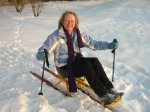 Angela research neuro physiotherapist trying a seated skiing device for going across the snow